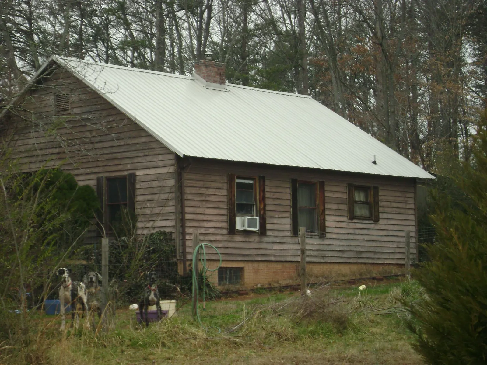 White metal roof on an old wood sided farmhouse, from a Metal Roof Installation job in Morning View